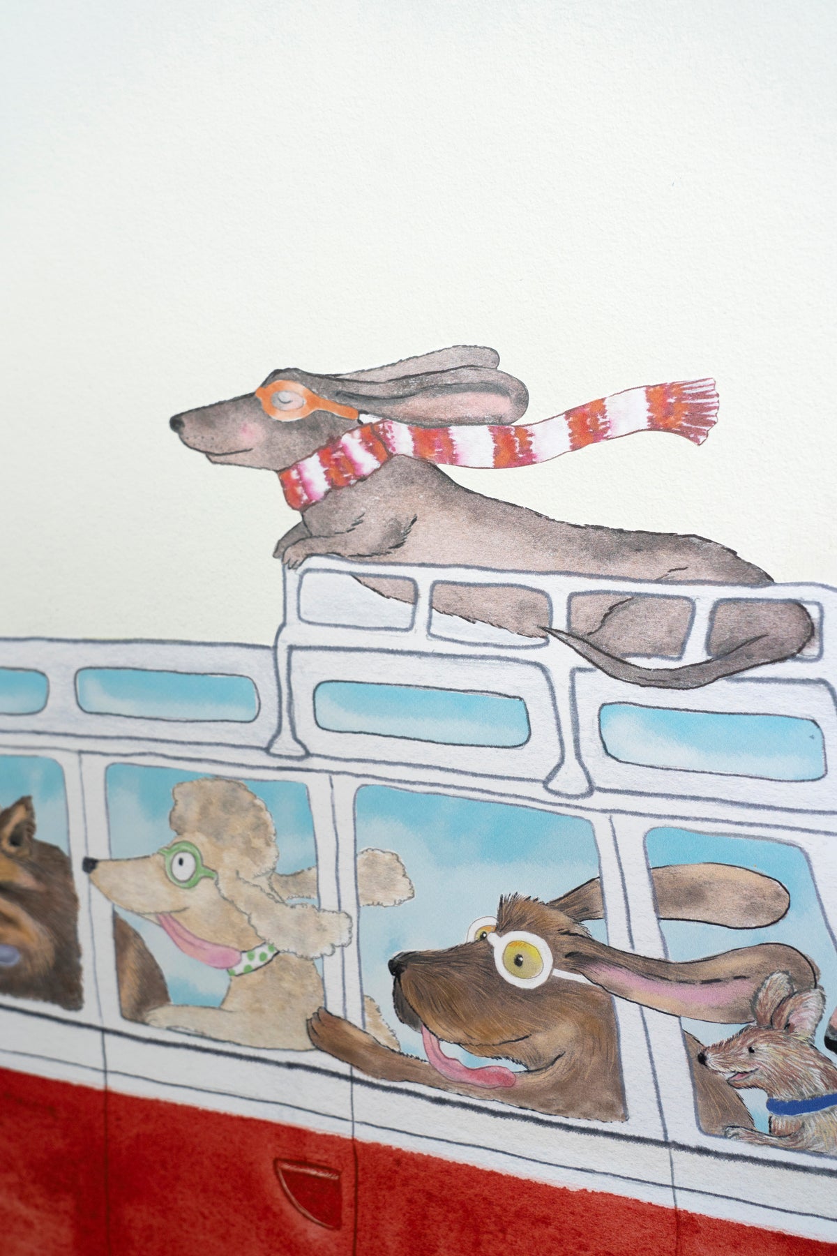 Close-up of a dachshund wearing a red and white scarf on the Red Camper wall decal