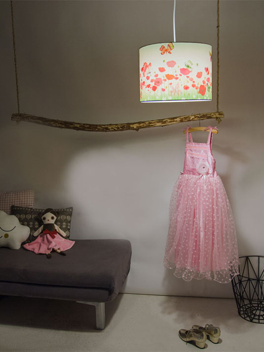 Butterflies pendant lamp by Hartendief lit above a daybed in the nursery, with a pink princess dress on the wall