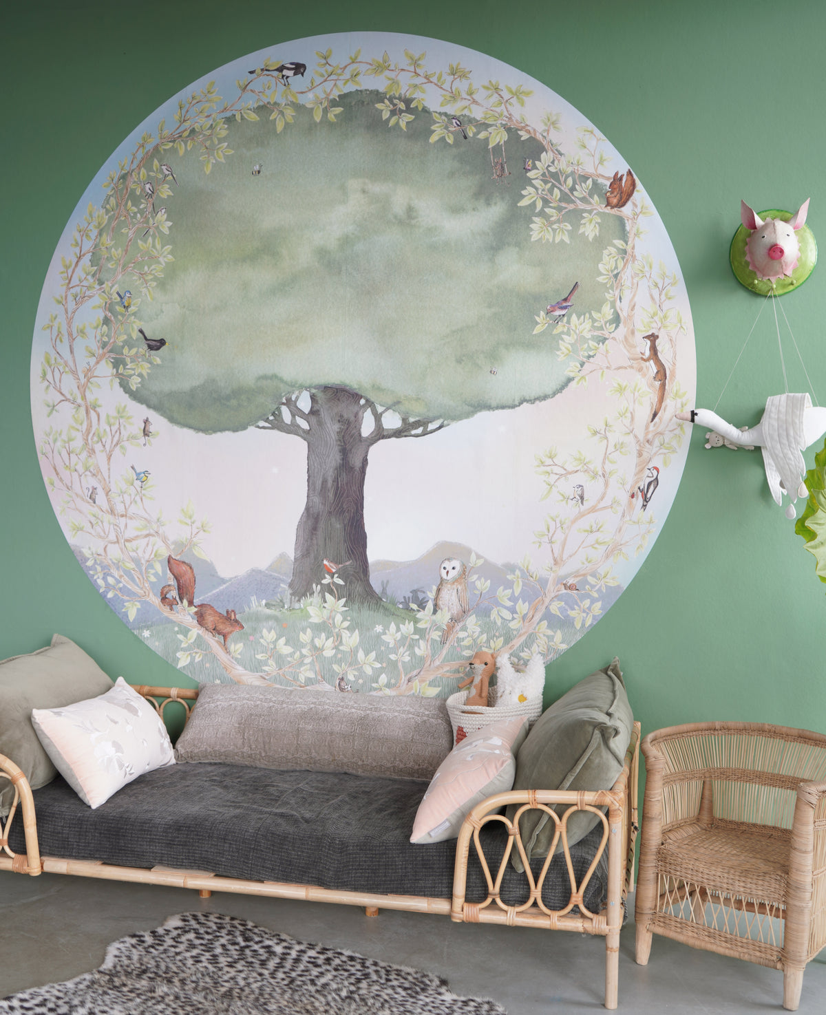 Life Tree wallpaper circle L by Hartendief in a nursery with dark bedding and an animal print rug