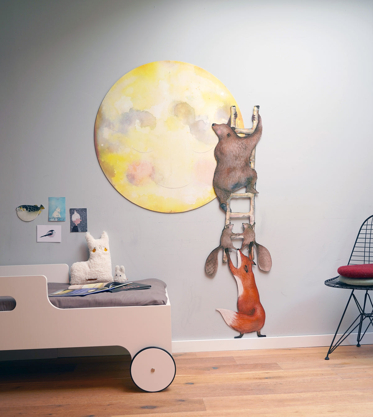 Maankus behangcirkel van Hartendief op een lichtgrijze muur met de Dieren op de Ladder muursticker naast een kinderbed
