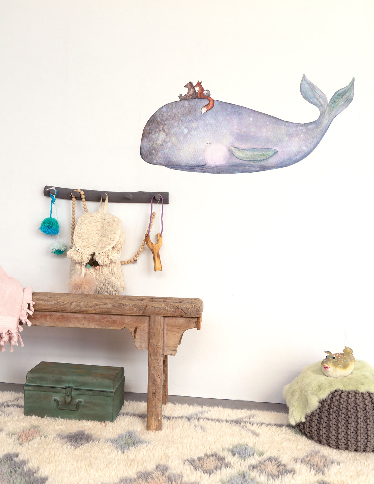 On the Back of the Whale wall decal by Hartendief on a white nursery wall above a wooden bench