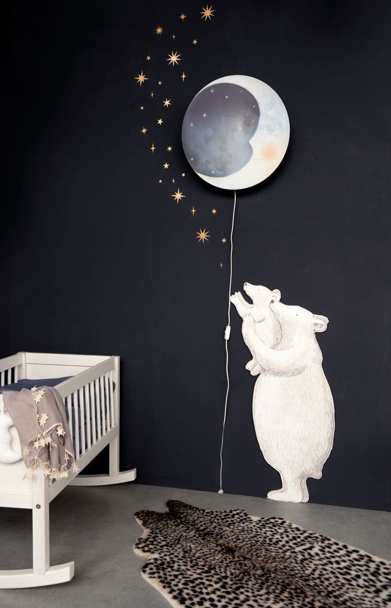 Gold star and moon stickers in a dark nursery with the Polar Bear wall decal and the Sleepy Eyes wall lamp